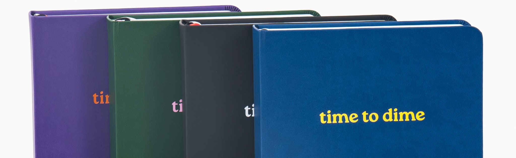 Four notebooks in different colors with 'time to dime' branding on a white background